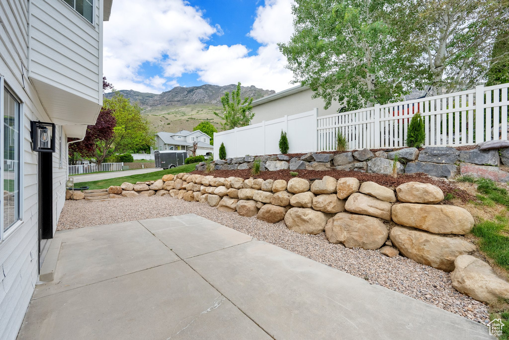 View of patio / terrace with a mountain view and fence