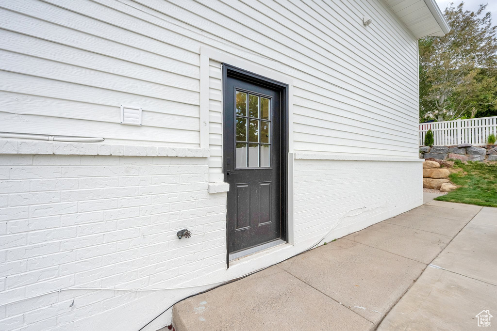 Entrance to property with fence and a patio