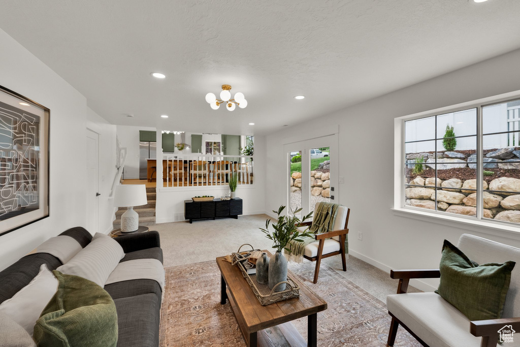 Carpeted living area featuring recessed lighting and baseboards
