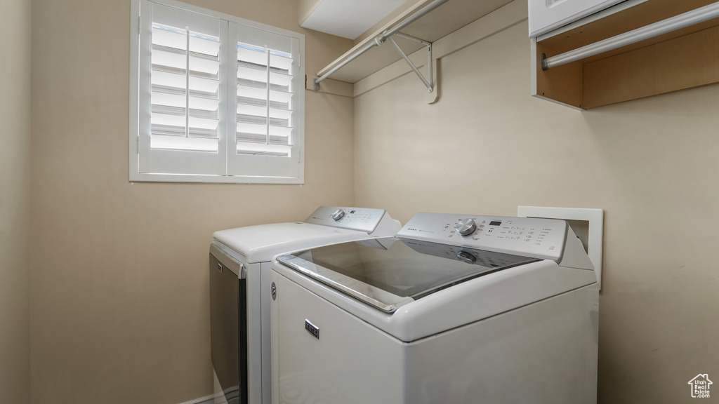 Washroom with washer and clothes dryer