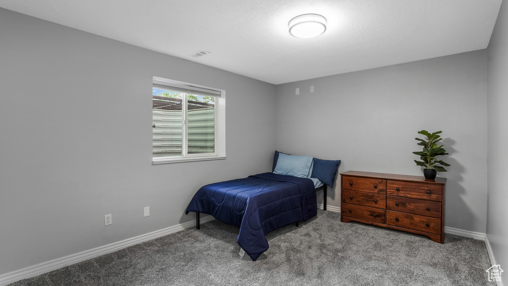 Carpeted bedroom with baseboards