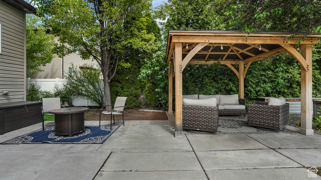 View of patio featuring an outdoor living space, a gazebo, and fence