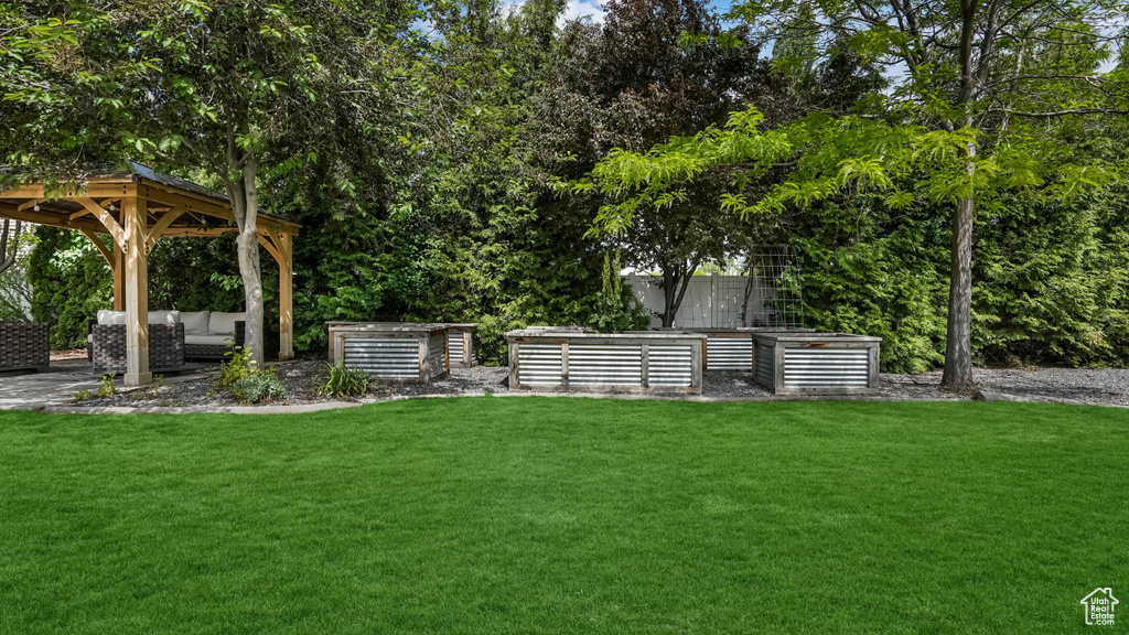 View of green lawn featuring a gazebo and outdoor lounge area