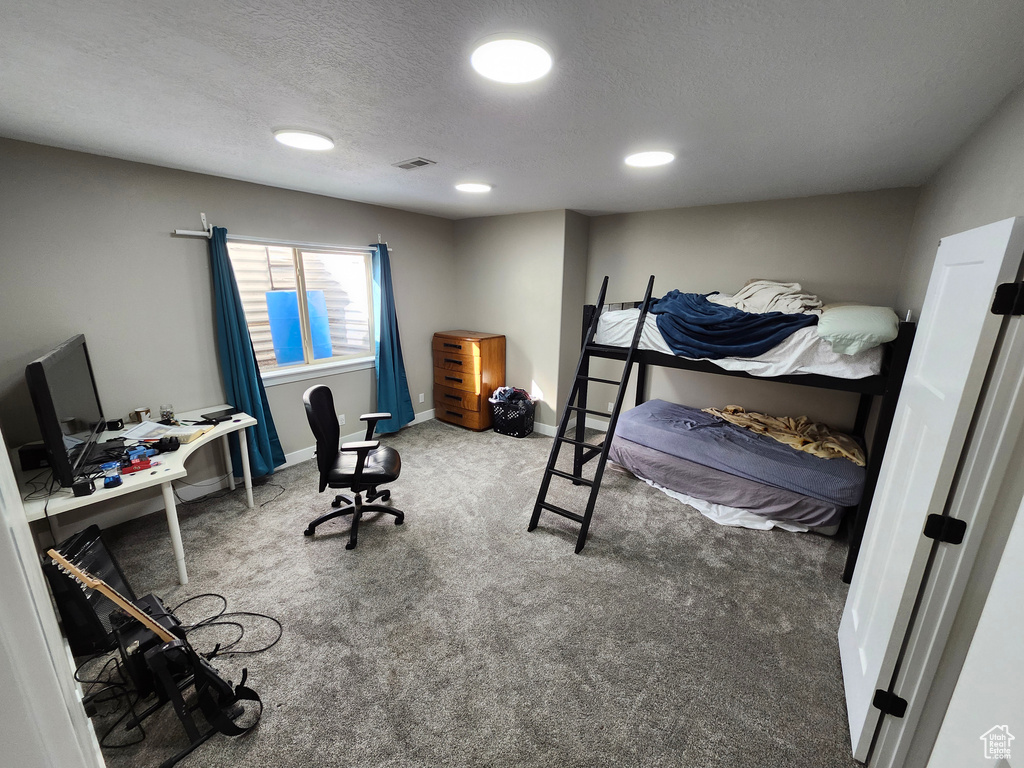 Bedroom with carpet floors, an office area, a textured ceiling, baseboards, and recessed lighting