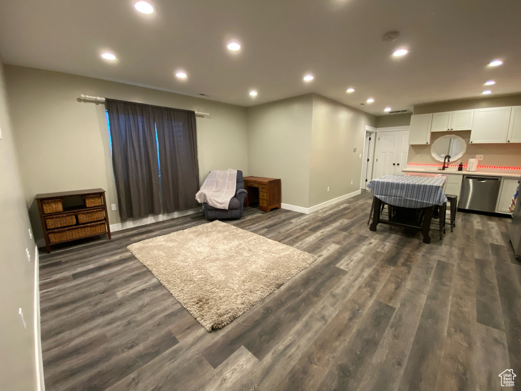 Living area with dark wood-style floors, baseboards, and recessed lighting