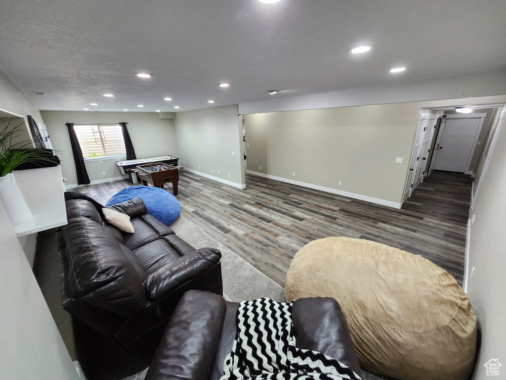 Living room featuring billiards, wood finished floors, recessed lighting, and baseboards