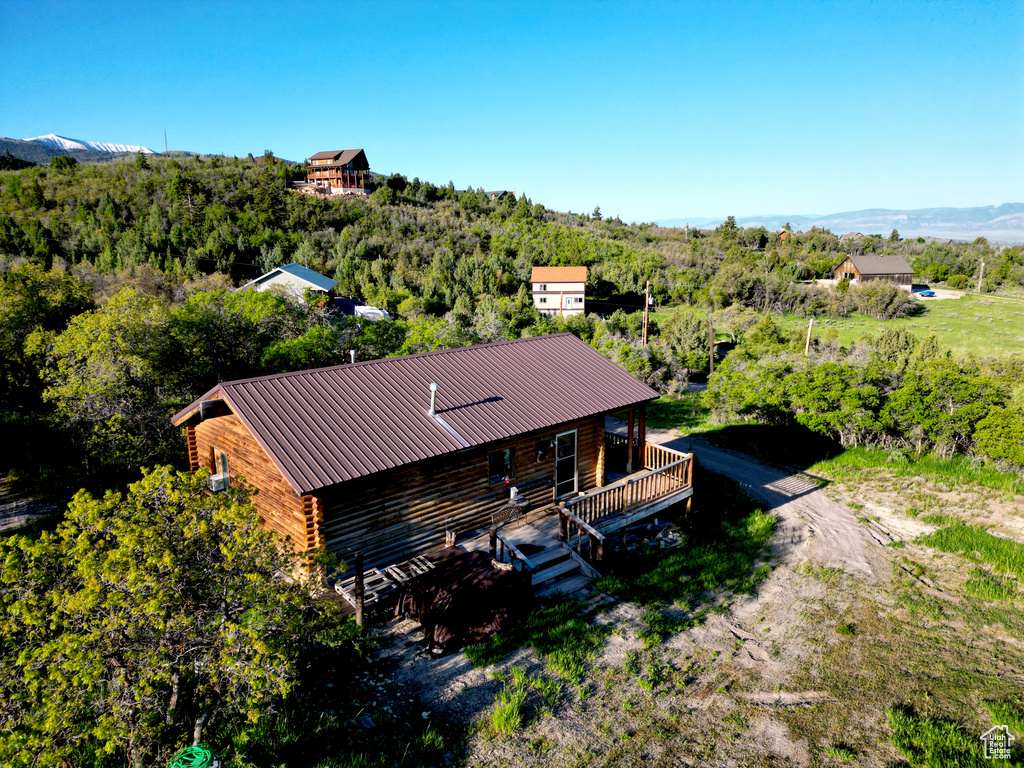 View of subject property with a heavily wooded area