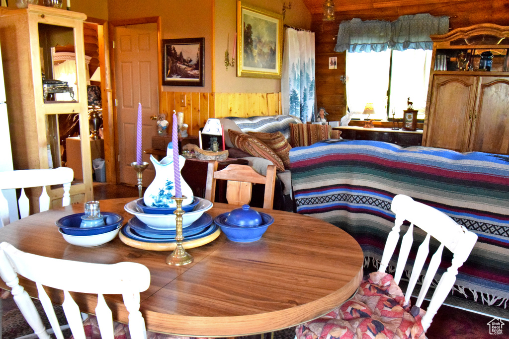 Dining area with wooden walls and a wainscoted wall