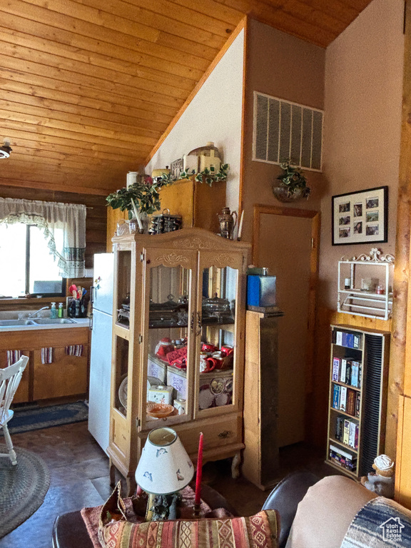 Living area featuring wooden ceiling and vaulted ceiling