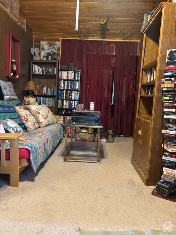 Bedroom with carpet floors, vaulted ceiling, and wood ceiling