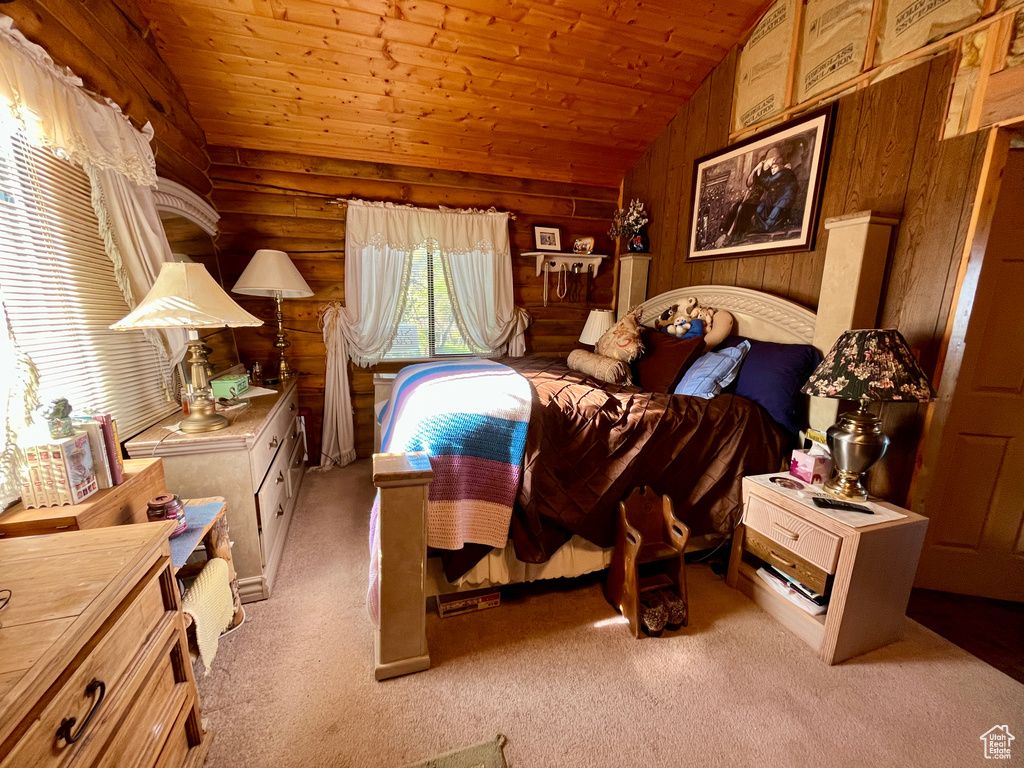 Bedroom featuring vaulted ceiling, wooden ceiling, and light carpet
