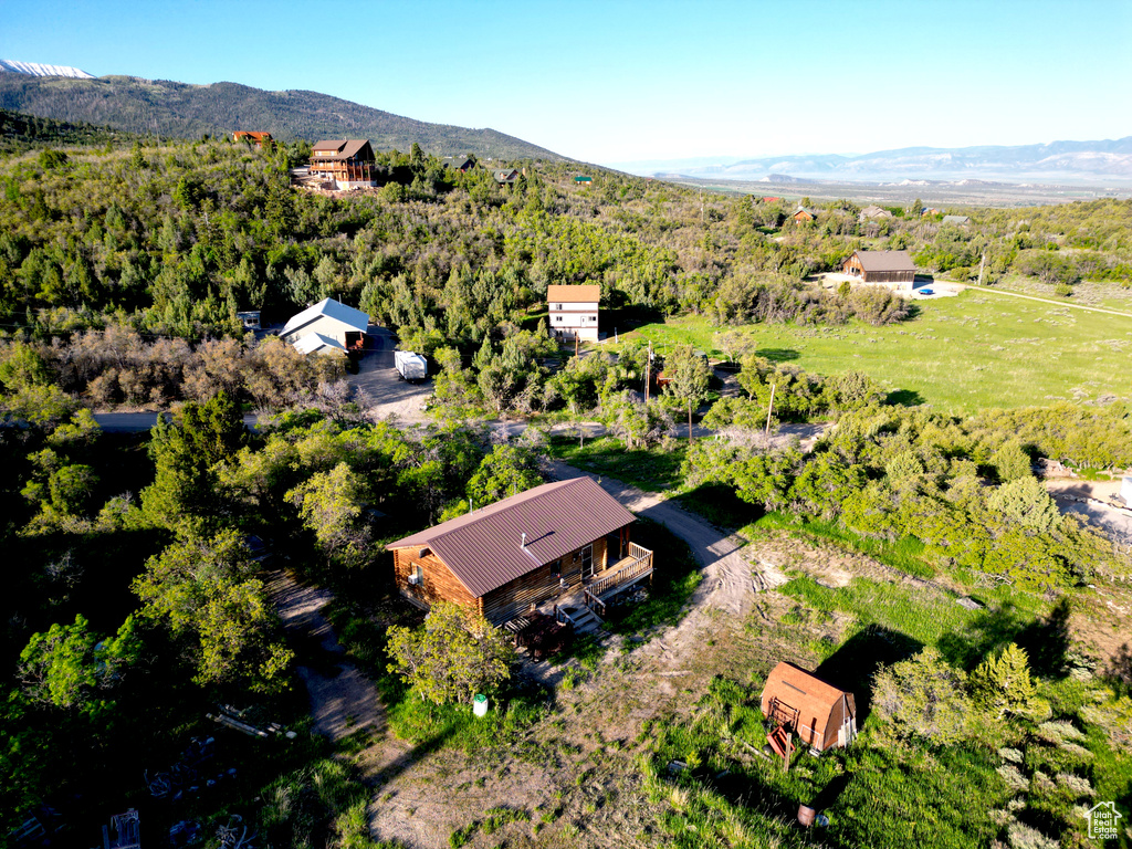 View of subject property with mountains and a forest