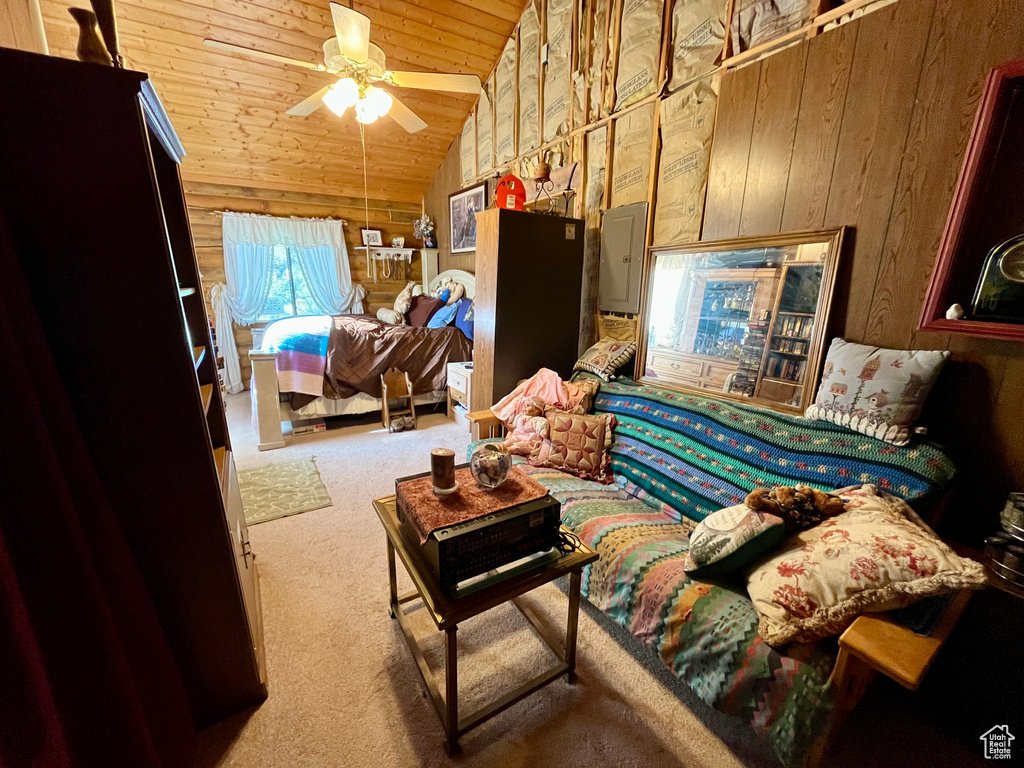 Carpeted bedroom with wooden ceiling, lofted ceiling, wooden walls, electric panel, and a ceiling fan