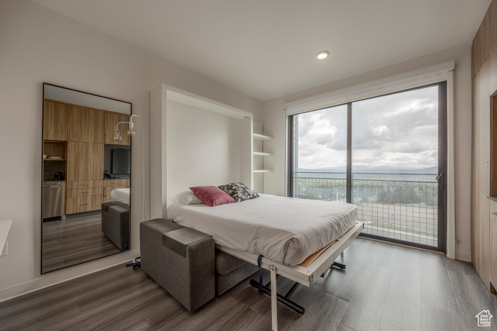 Bedroom featuring access to outside, wood finished floors, baseboards, and recessed lighting