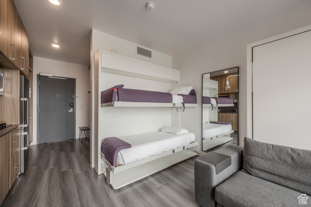 Bedroom featuring dark wood-style floors and recessed lighting