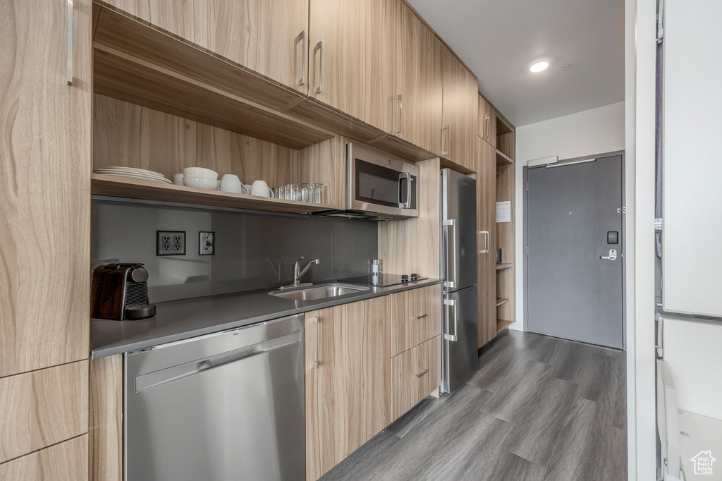 Kitchen with appliances with stainless steel finishes, open shelves, modern cabinets, and light brown cabinets