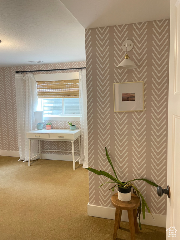 Bathroom featuring wallpapered walls and baseboards