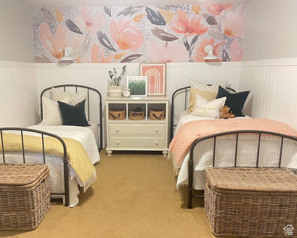 Carpeted bedroom featuring a wainscoted wall