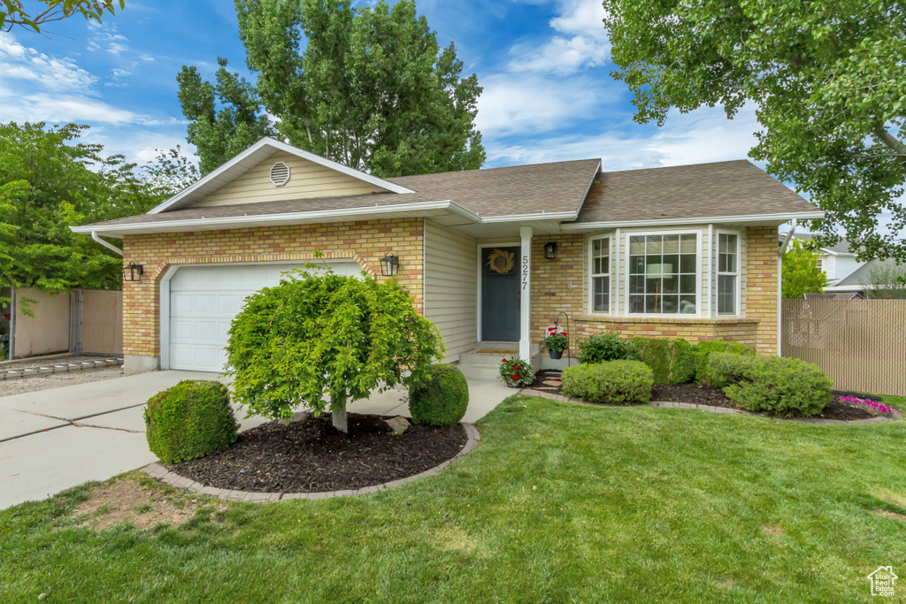 Ranch-style house featuring a garage, concrete driveway, brick siding, and roof with shingles