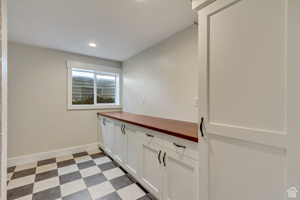 Washroom featuring recessed lighting, light floors, and baseboards