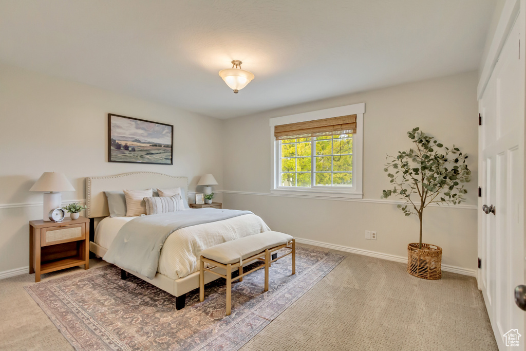 Carpeted bedroom featuring baseboards