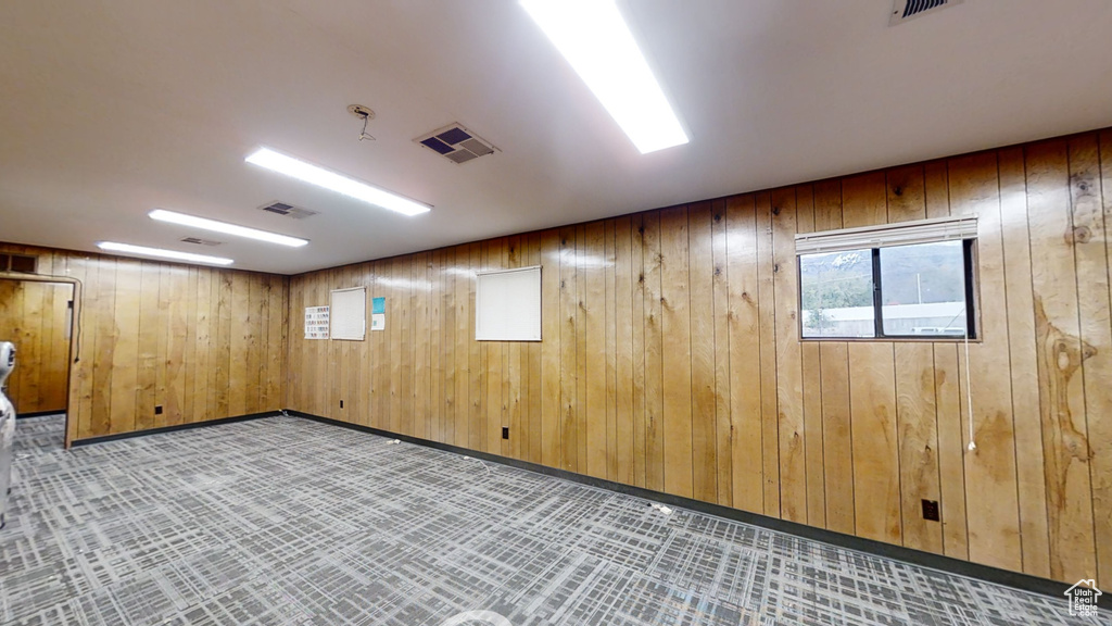 Basement featuring wooden walls
