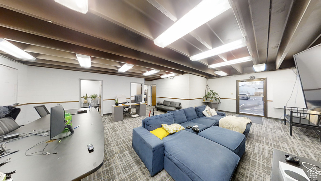 Carpeted living room with beamed ceiling