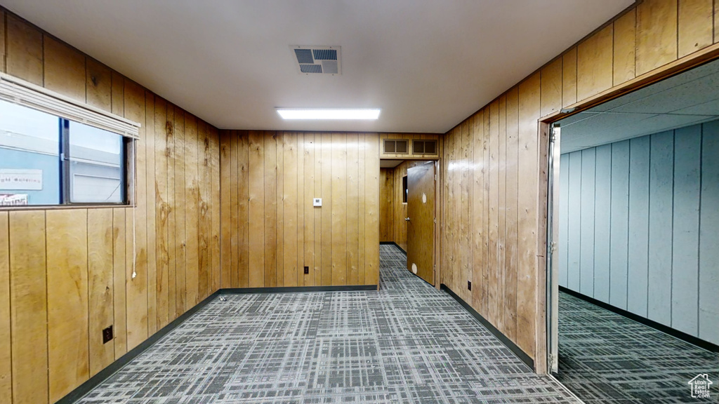 Unfurnished room with wood walls and baseboards