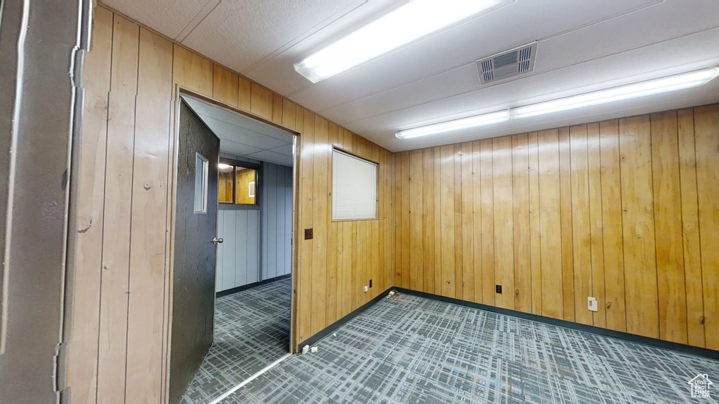Empty room with baseboards and wooden walls