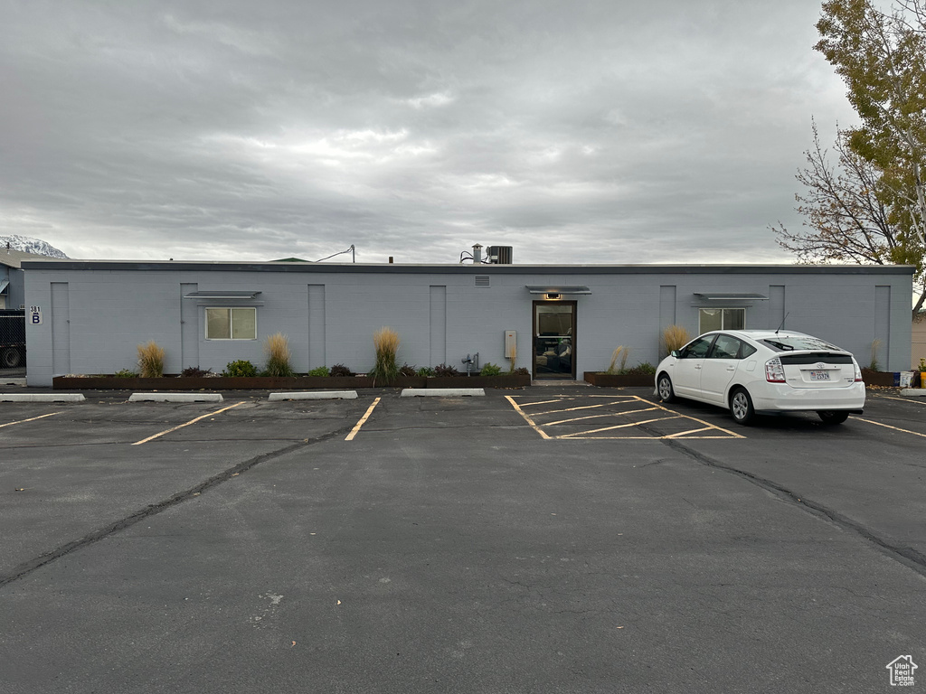 View of building exterior featuring uncovered parking