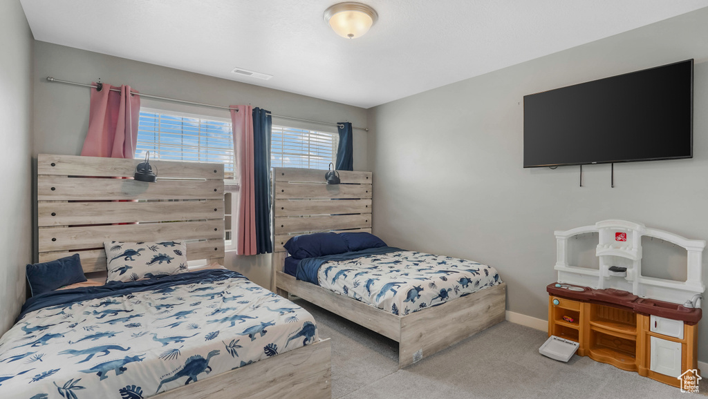 Carpeted bedroom featuring baseboards