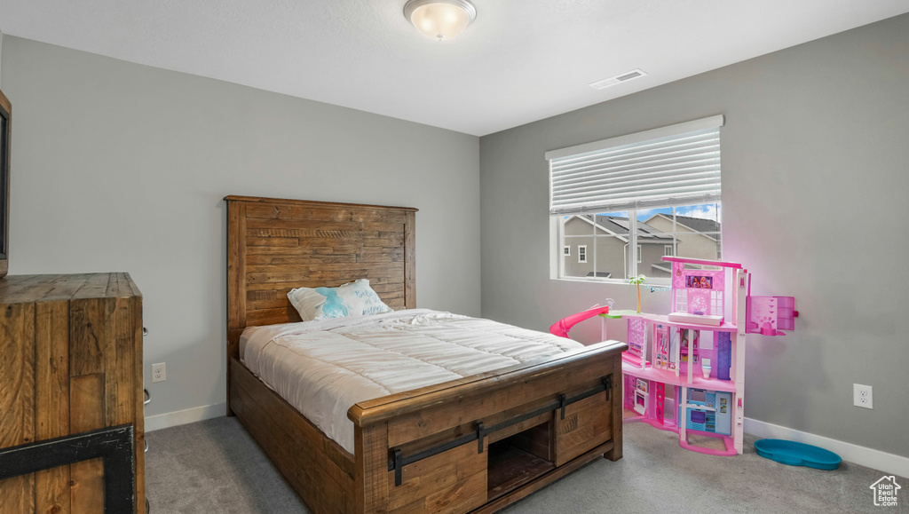 Carpeted bedroom featuring baseboards