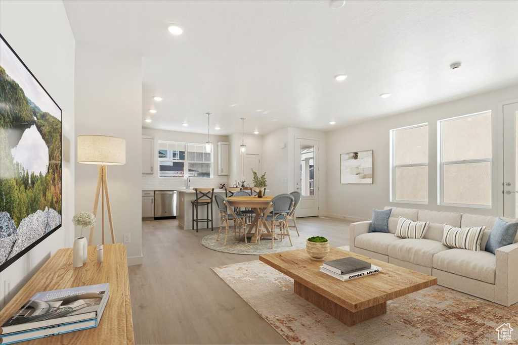 Living area featuring light wood finished floors, recessed lighting, and baseboards