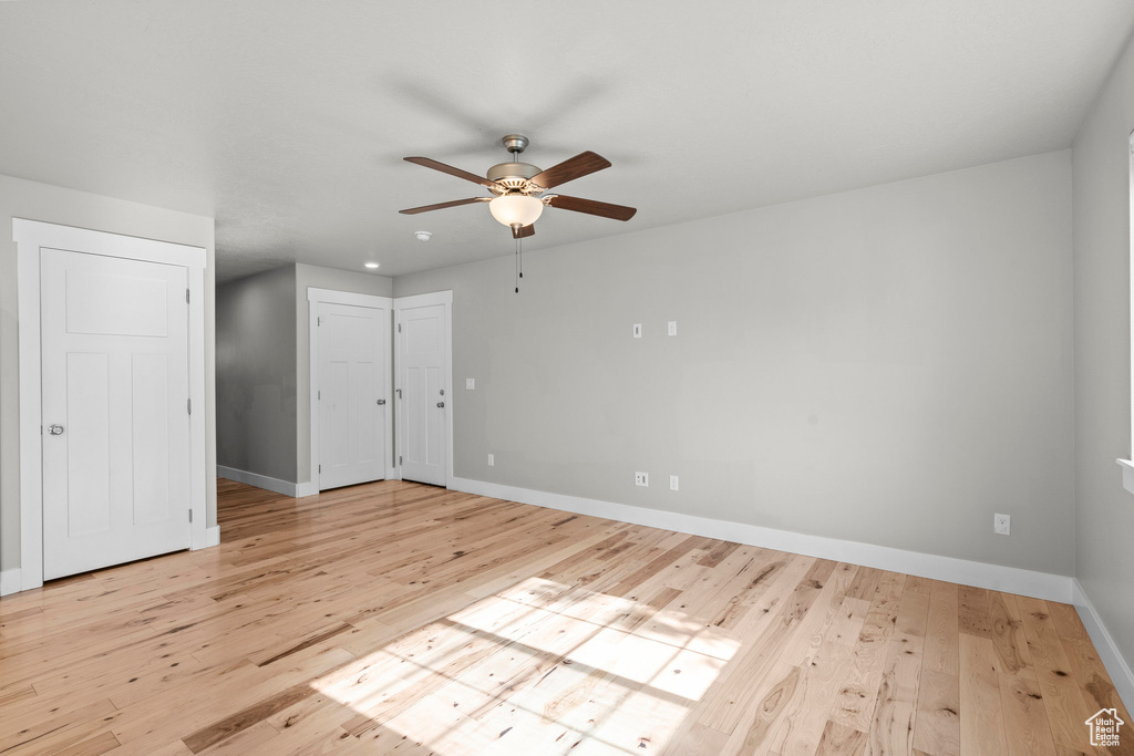 Unfurnished bedroom featuring baseboards, wood finished floors, and a ceiling fan