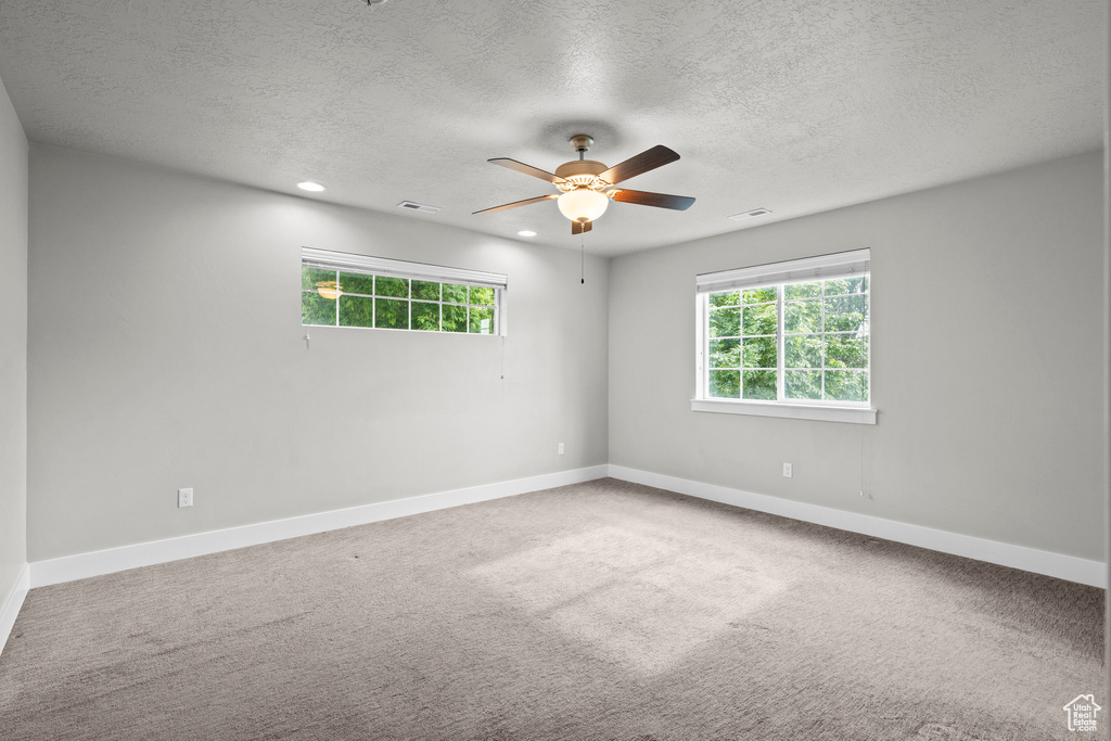 Spare room with a textured ceiling, baseboards, a ceiling fan, carpet flooring, and recessed lighting