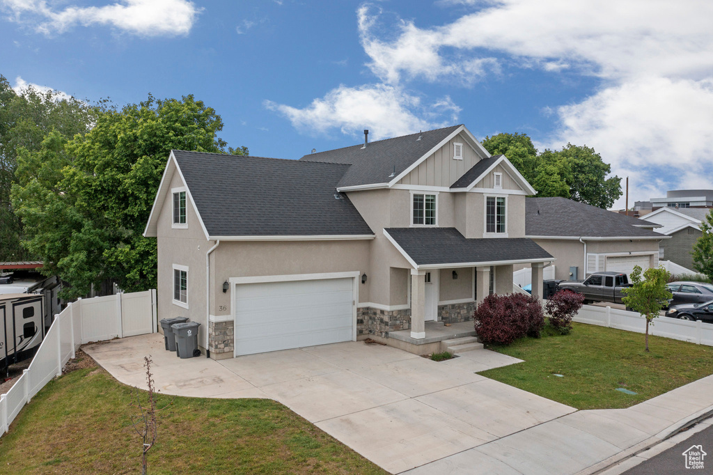 Craftsman house with stone siding, a porch, a garage, concrete driveway, and stucco siding