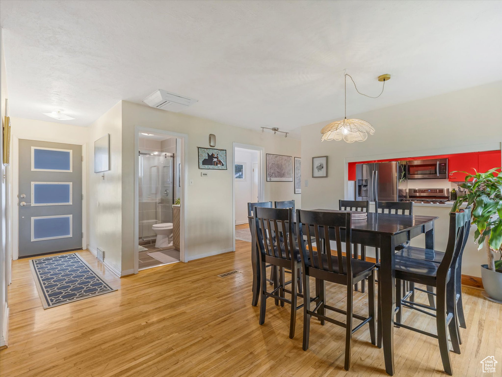 Dining room with light wood-style flooring and baseboards