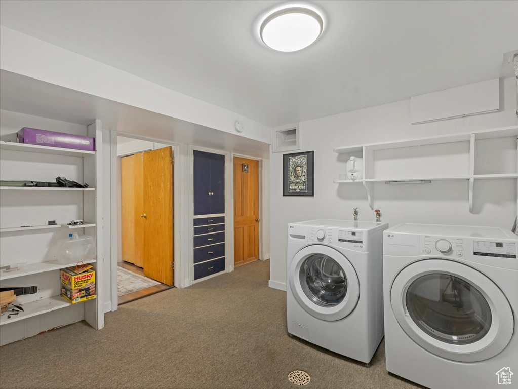 Washroom with separate washer and dryer and carpet flooring