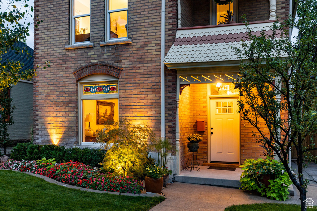 View of exterior entry featuring brick siding