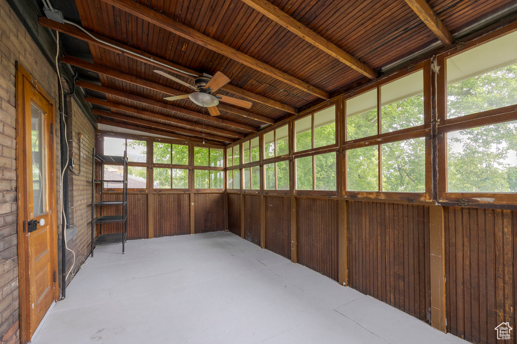 Unfurnished sunroom featuring a ceiling fan