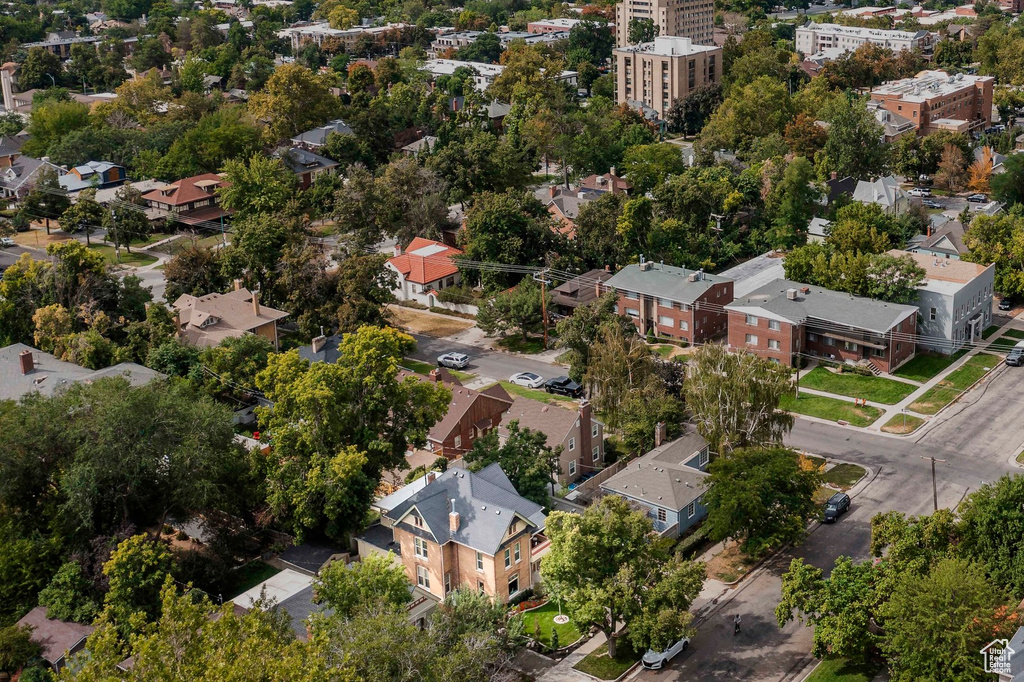 Aerial view of property and surrounding area featuring nearby suburban area