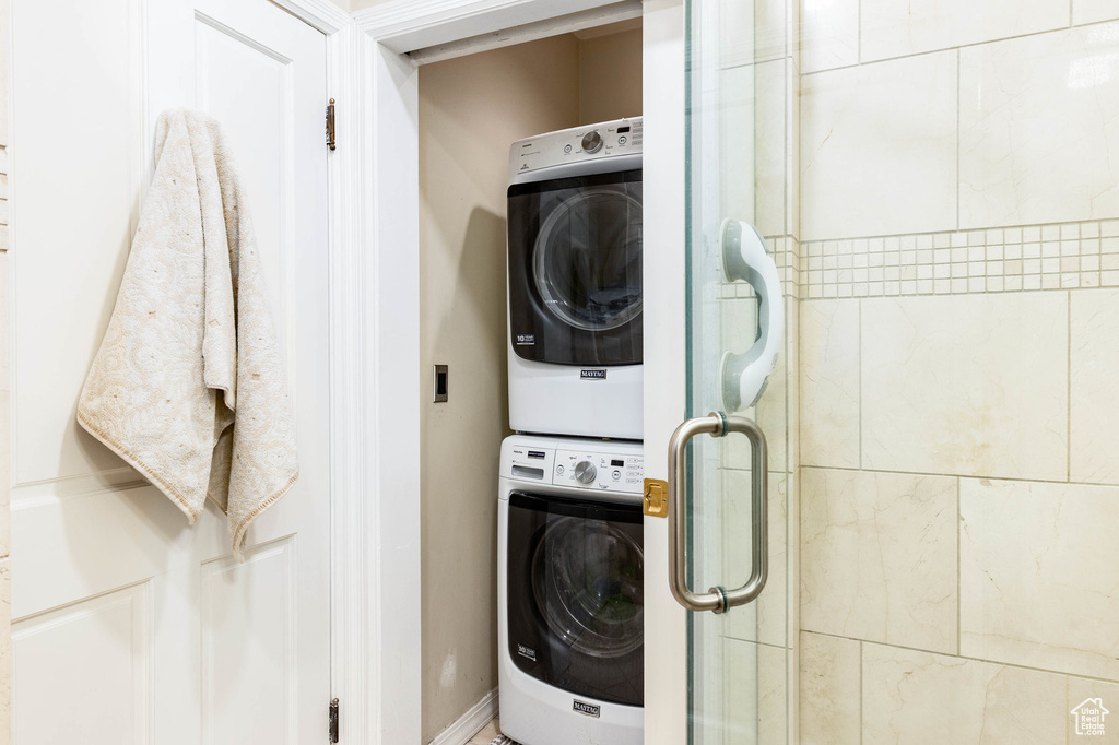 Clothes washing area featuring stacked washer / dryer
