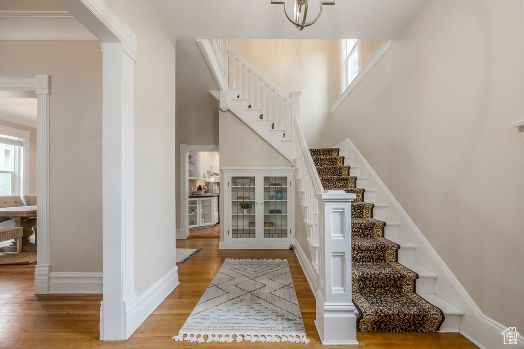 Foyer entrance featuring wood finished floors, stairway, and baseboards