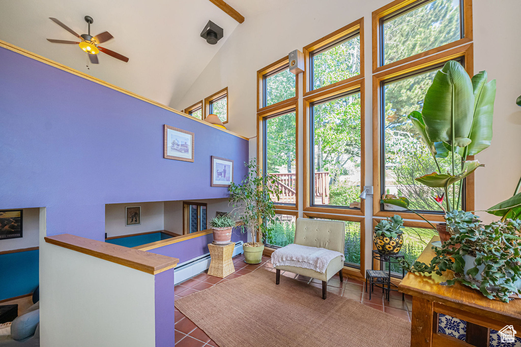Sunroom / solarium with lofted ceiling and a baseboard heating unit