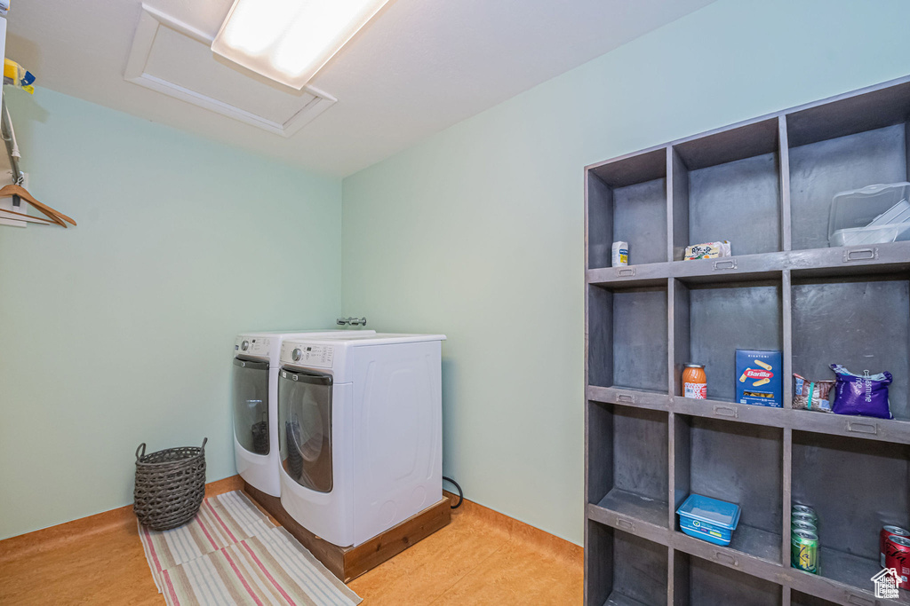 Laundry area featuring attic access and independent washer and dryer