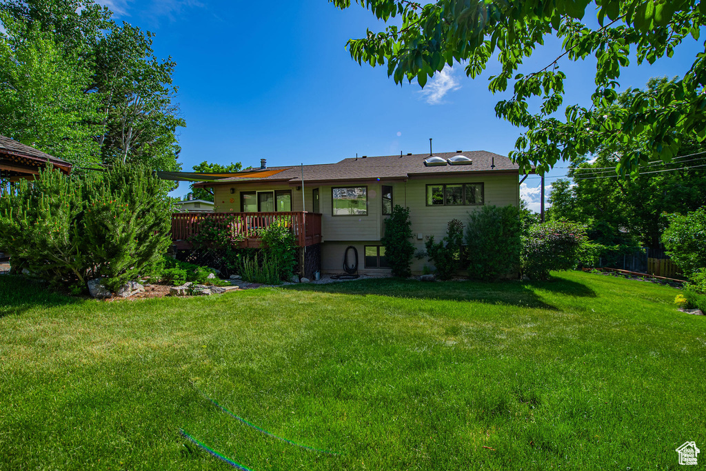 Back of house with a deck