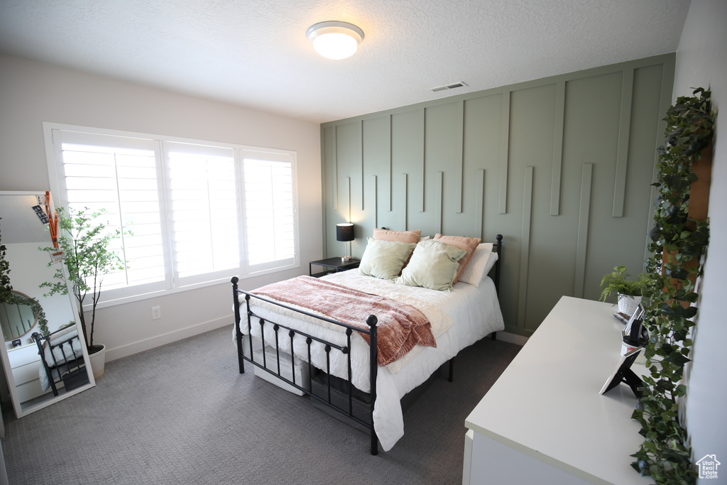 Carpeted bedroom featuring baseboards
