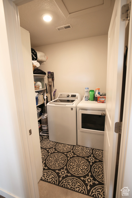 Washroom featuring independent washer and dryer, recessed lighting, and tile patterned flooring