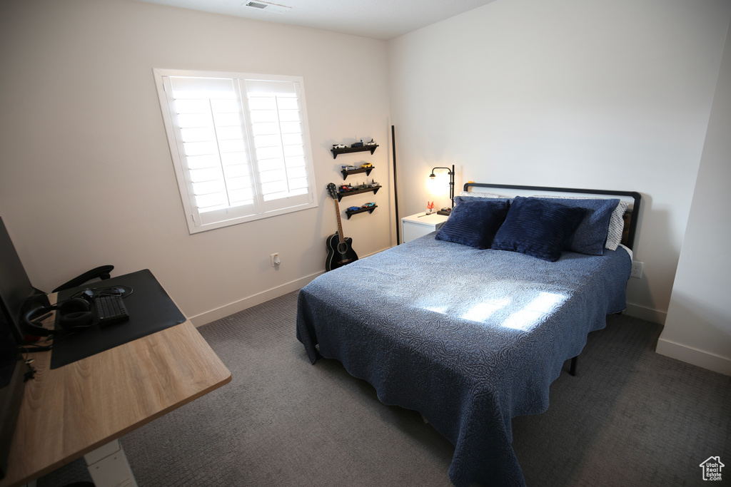 Bedroom with carpet floors and baseboards