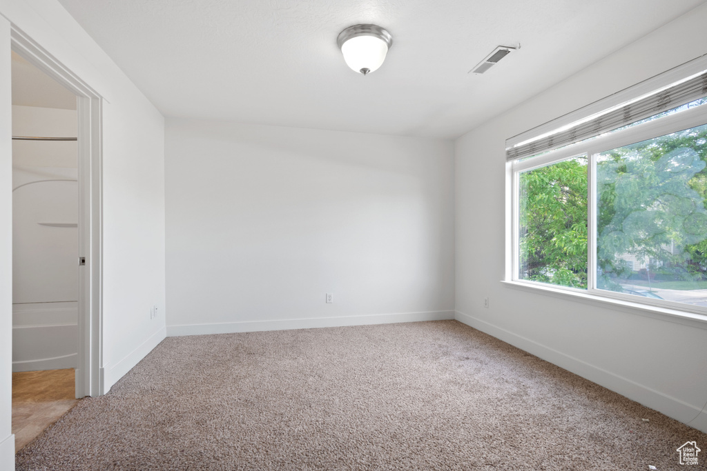 Empty room with carpet floors and baseboards